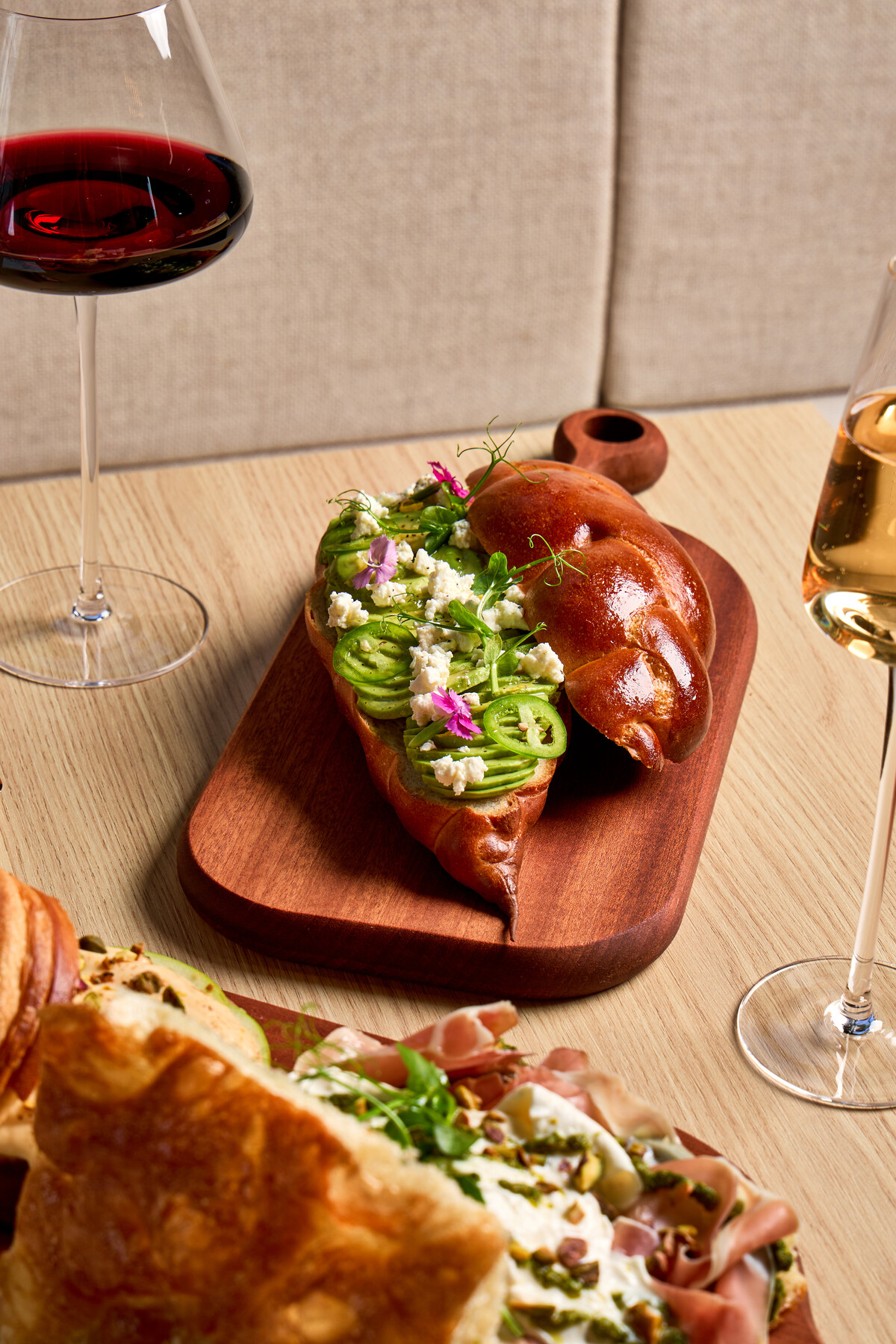 Avocado brioche sandwich with a burrata and prosciutto croissant spread at Péché Mignon