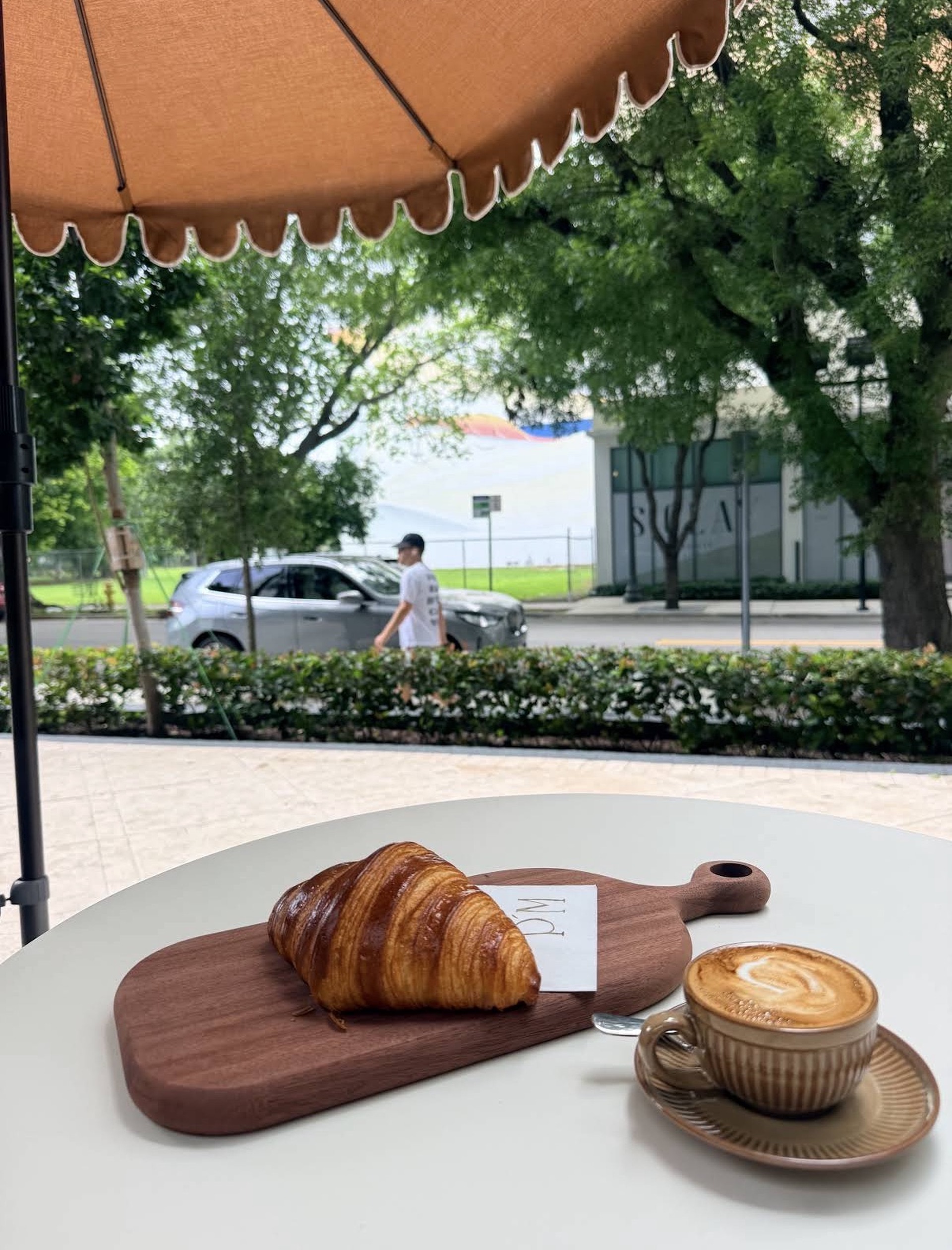 Croissant and coffee on the Péché Mignon patio